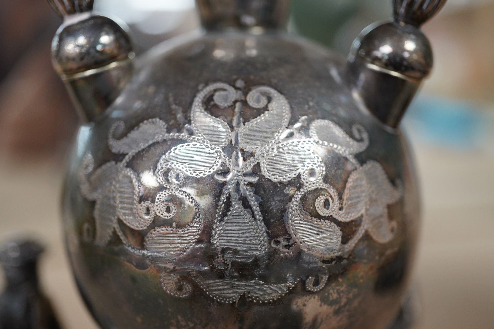 A Victorian plated cigar lamp decorated with seated Persian figures, 14cm high. Condition - fair